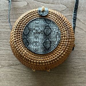 Romeo Roma straw bag with black snake leather pattern detailing.